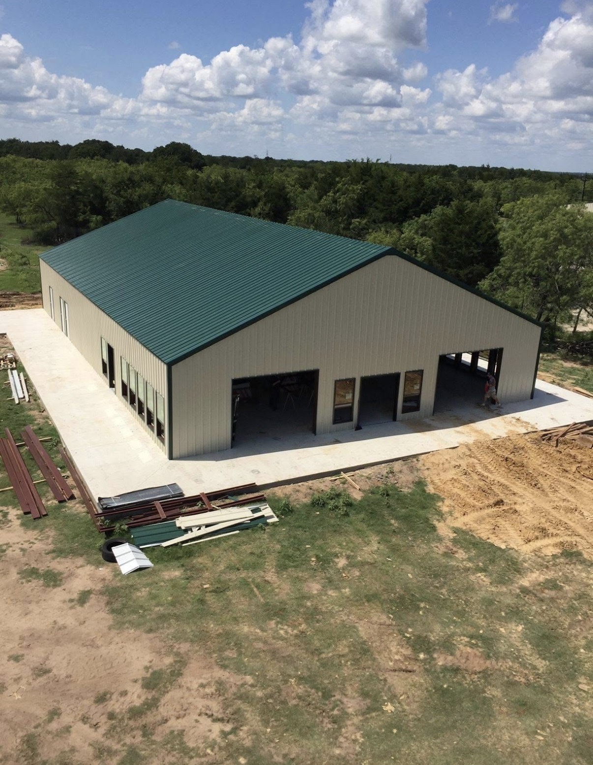 Large custom metal shop · pitched roof, multiple entries and concrete apron