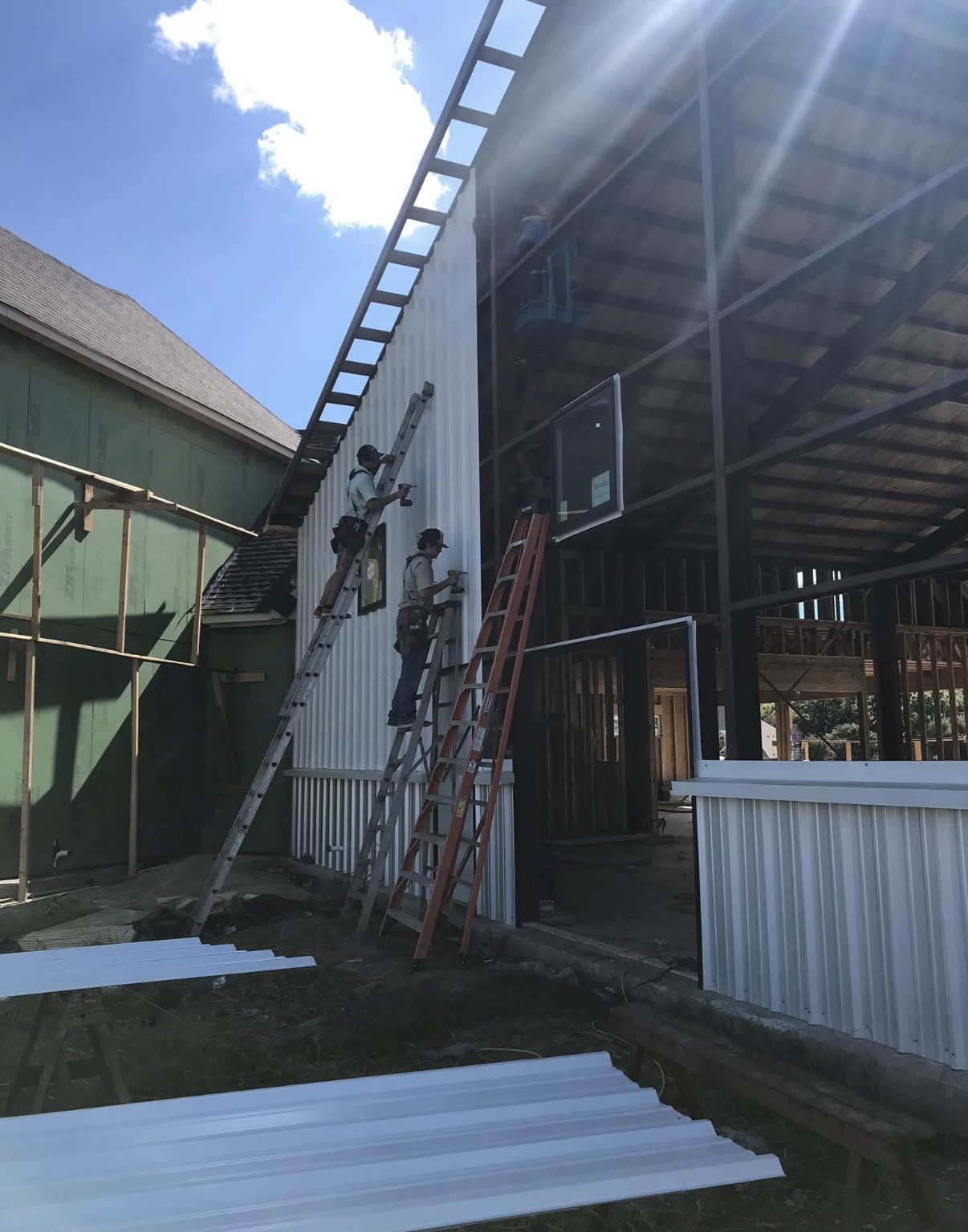 Whit-Tom crew installing metal siding and windows