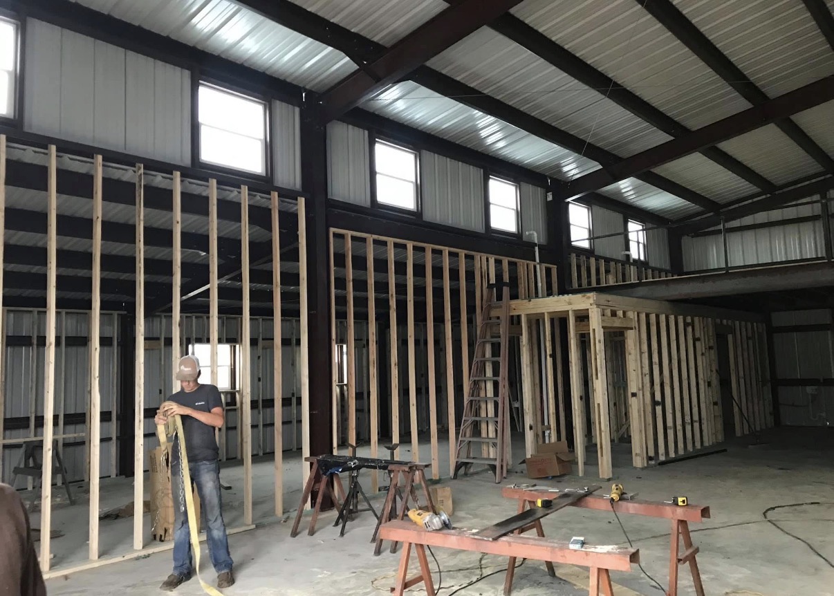 Interior rooms and loft space framed inside a red-iron building